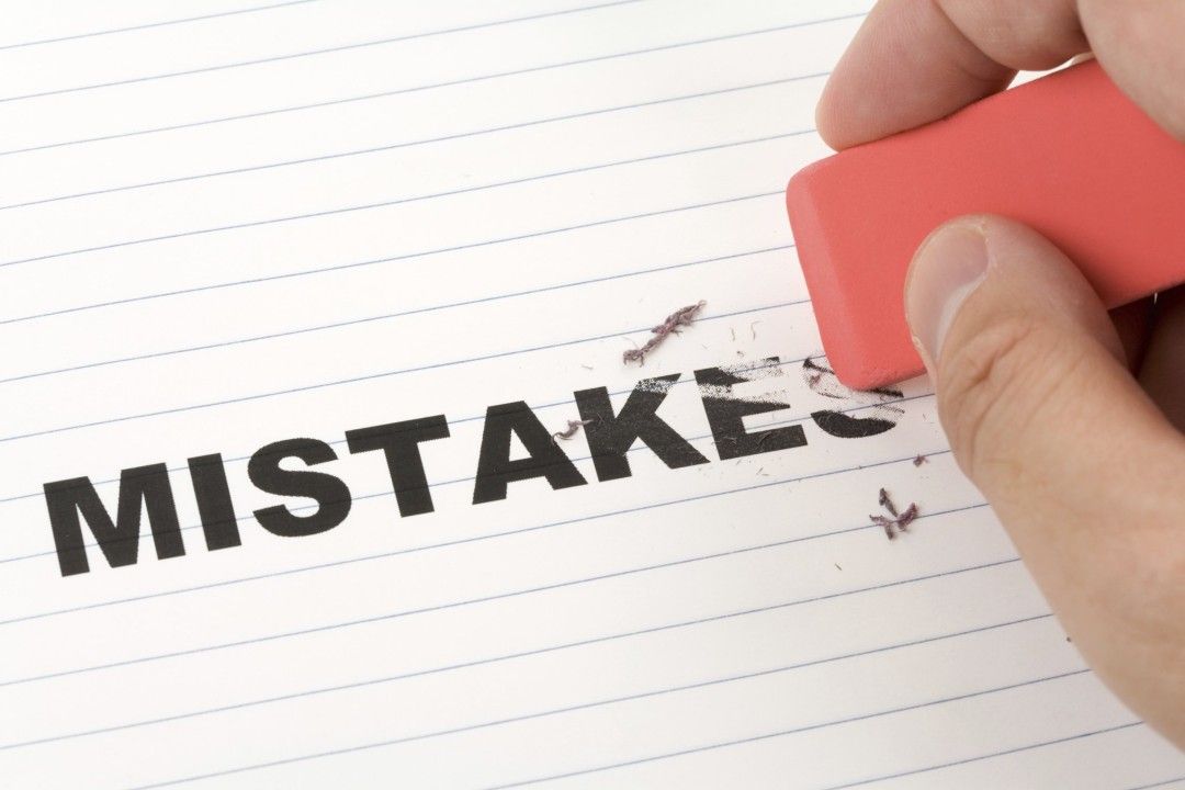 the word mistake written across paper with a person trying to erase it - business growth