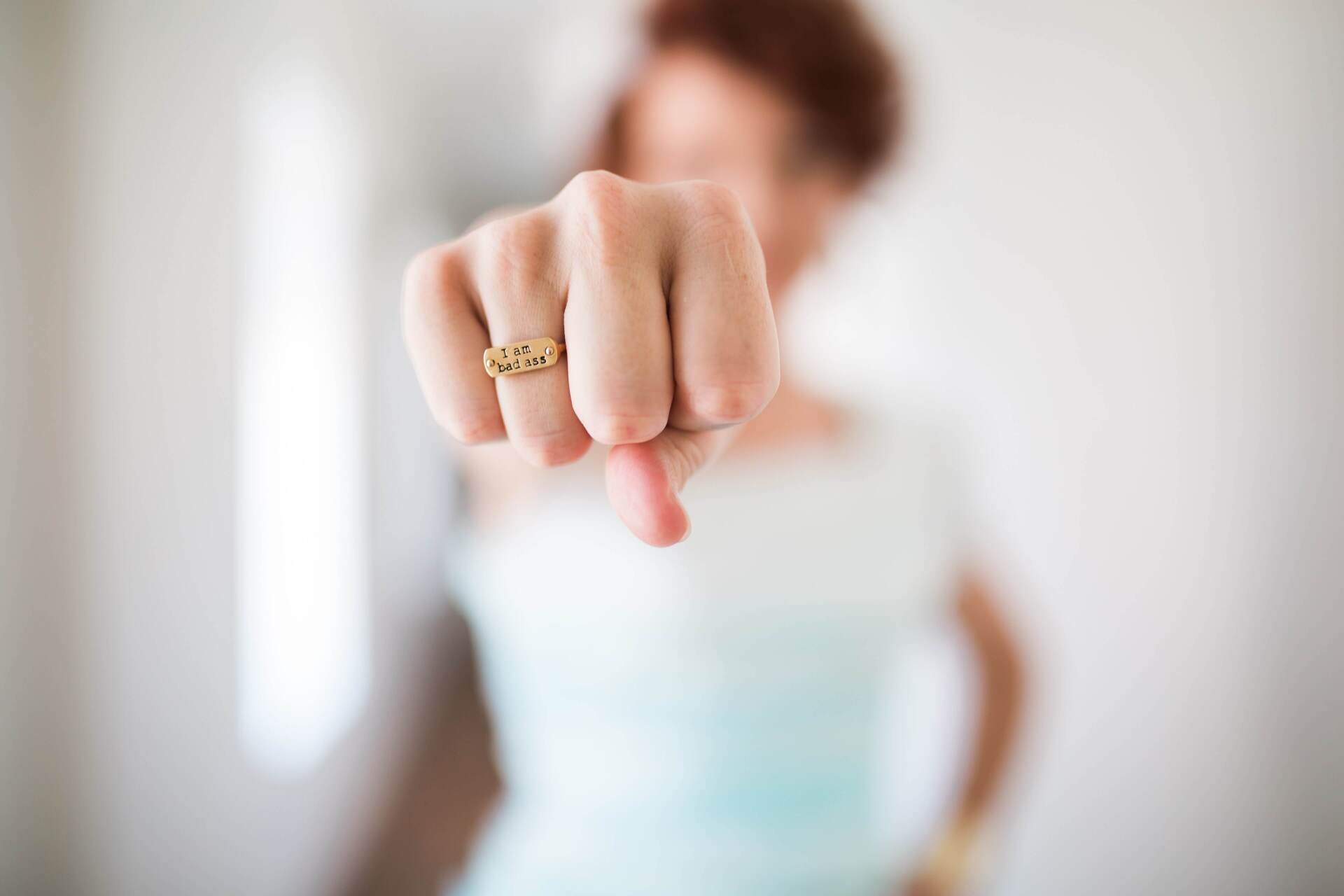 Woman with fist towards the camera - Small Business Growth Coaching