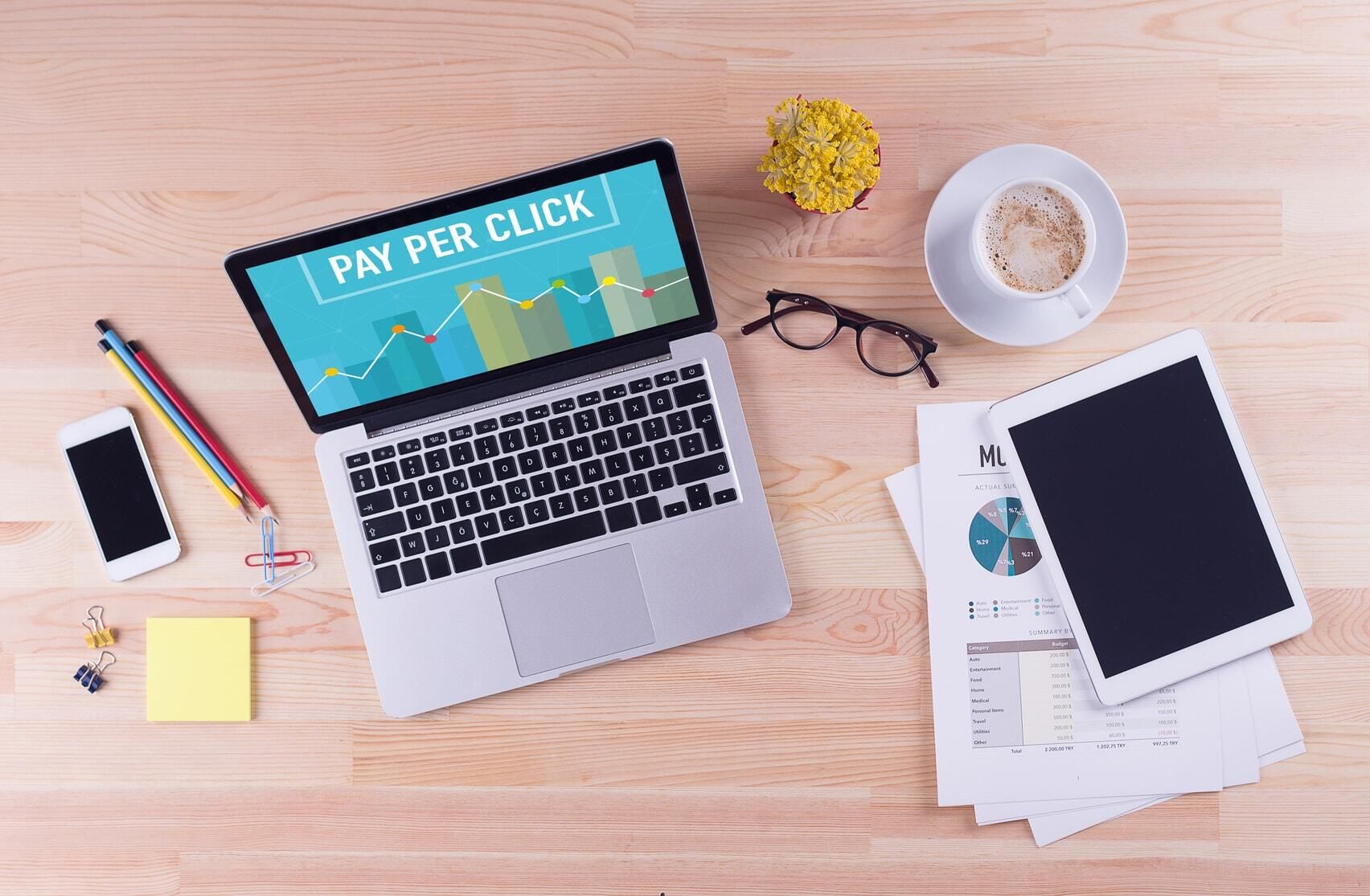 stationary, laptop computer with pay per click on screen placed neatly on a desk