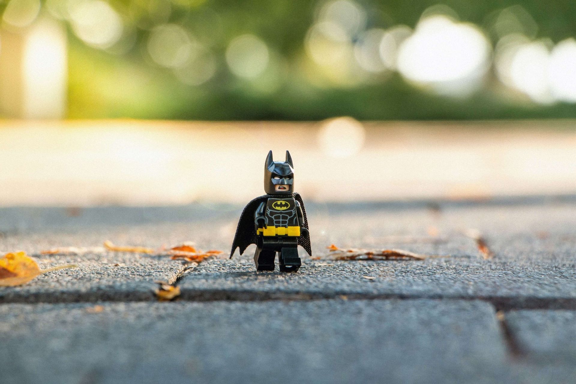 lego batman standing on a pavement