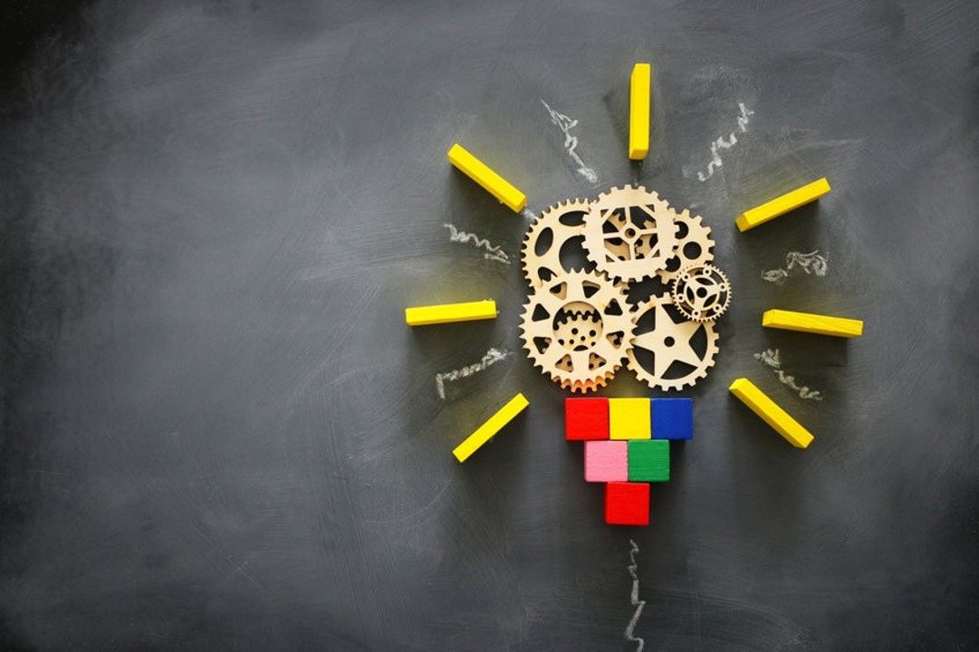 Lightbulb made out of building blocks on a blackboard - Strategic Thinking