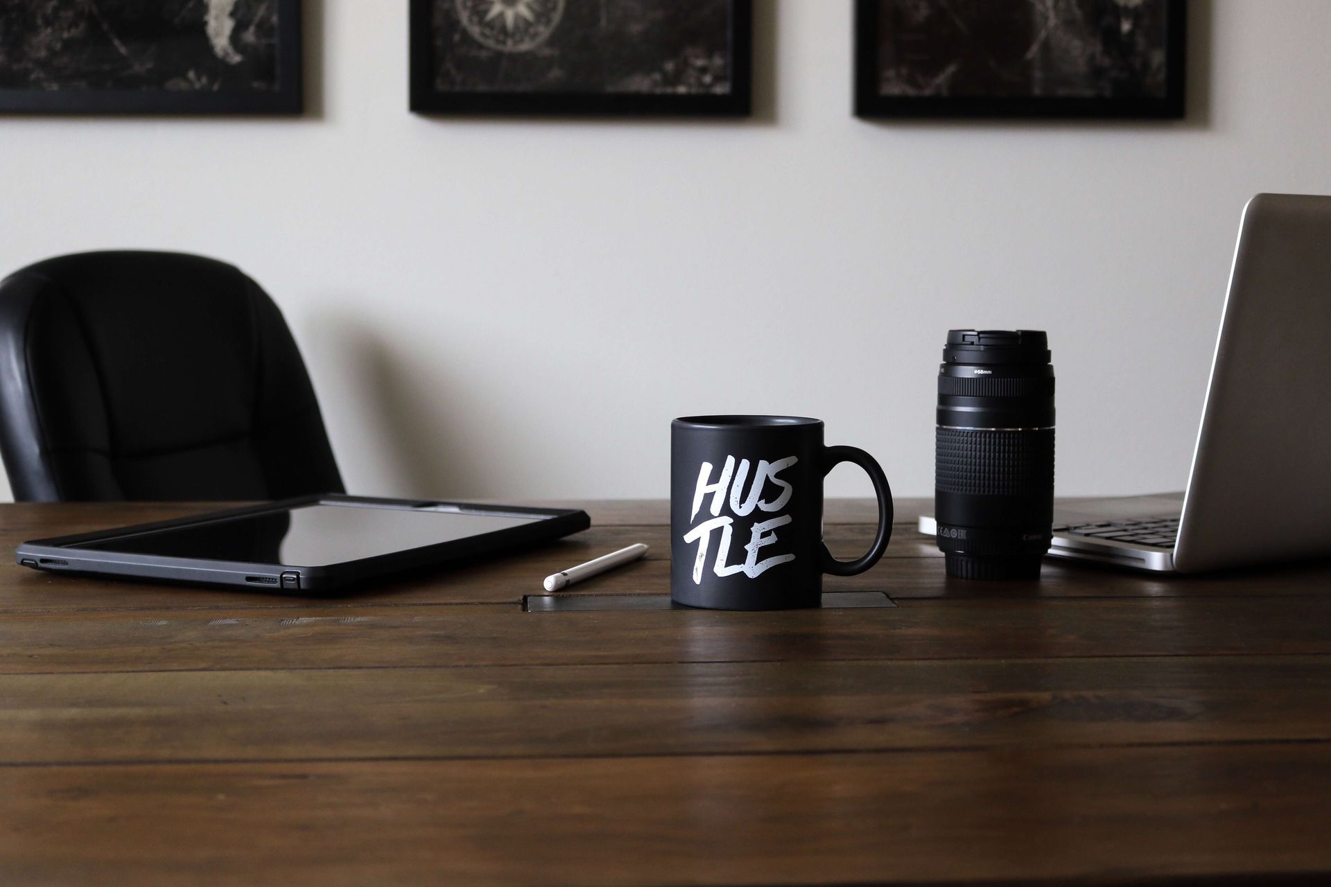 Office Desk with Laptop and Mug that has Hustle on it - Small Business Growth Coaching
