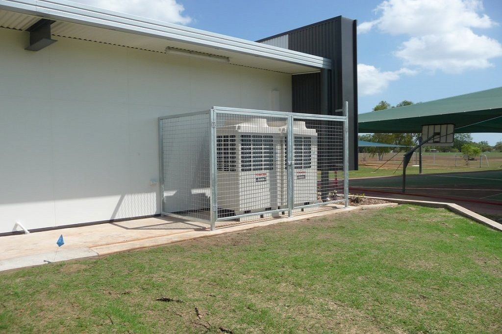 Two Air Conditioners Are Sitting Outside of a Building — Preston’s NT in Winnellie, NT