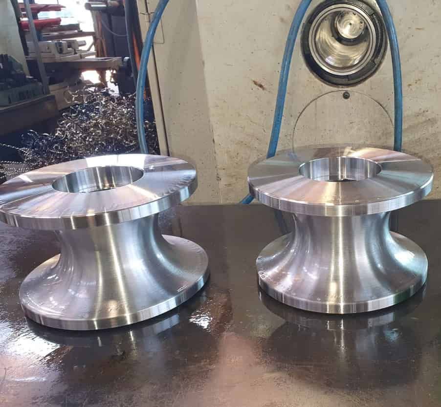 Two Metal Wheels Are Sitting on a Table in a Factory — Preston’s NT in Winnellie, NT