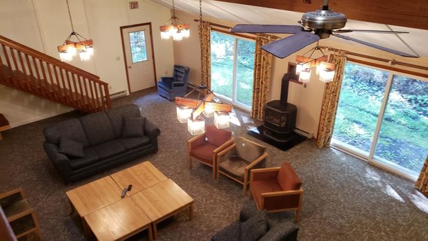 An aerial view of a living room with furniture and a ceiling fan.