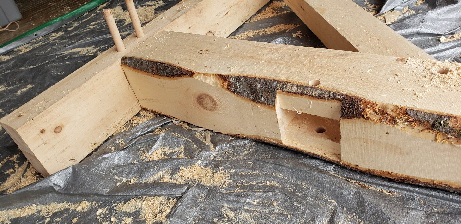 A piece of wood with a hole in it is laying on a table.