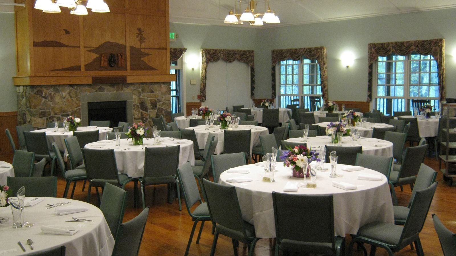 A large room with tables and chairs set up for a banquet