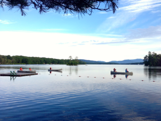 A group of people in canoes on a lake