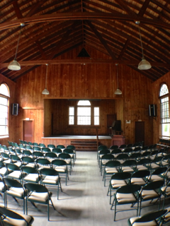 Rows of chairs in an auditorium with a stage in the background