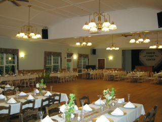 A large room with tables and chairs and a sign that says jesus point center