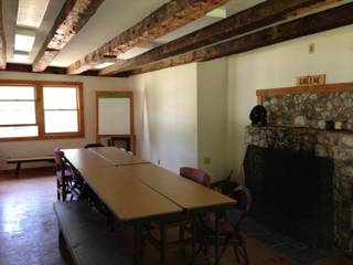 A room with tables and chairs and a sign that says greek