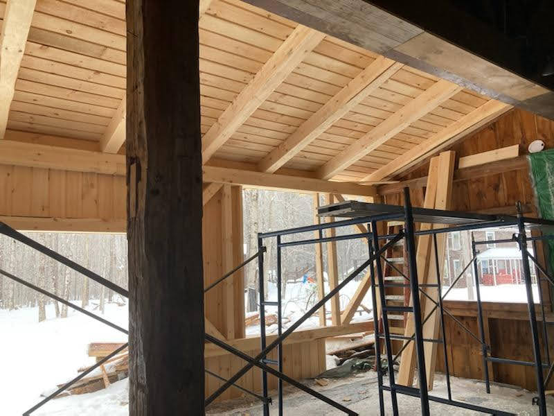 A building under construction with scaffolding and a wooden ceiling