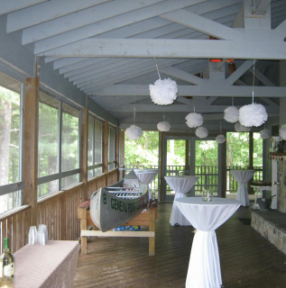 A room with tables and a canoe that says ' coastline ' on it