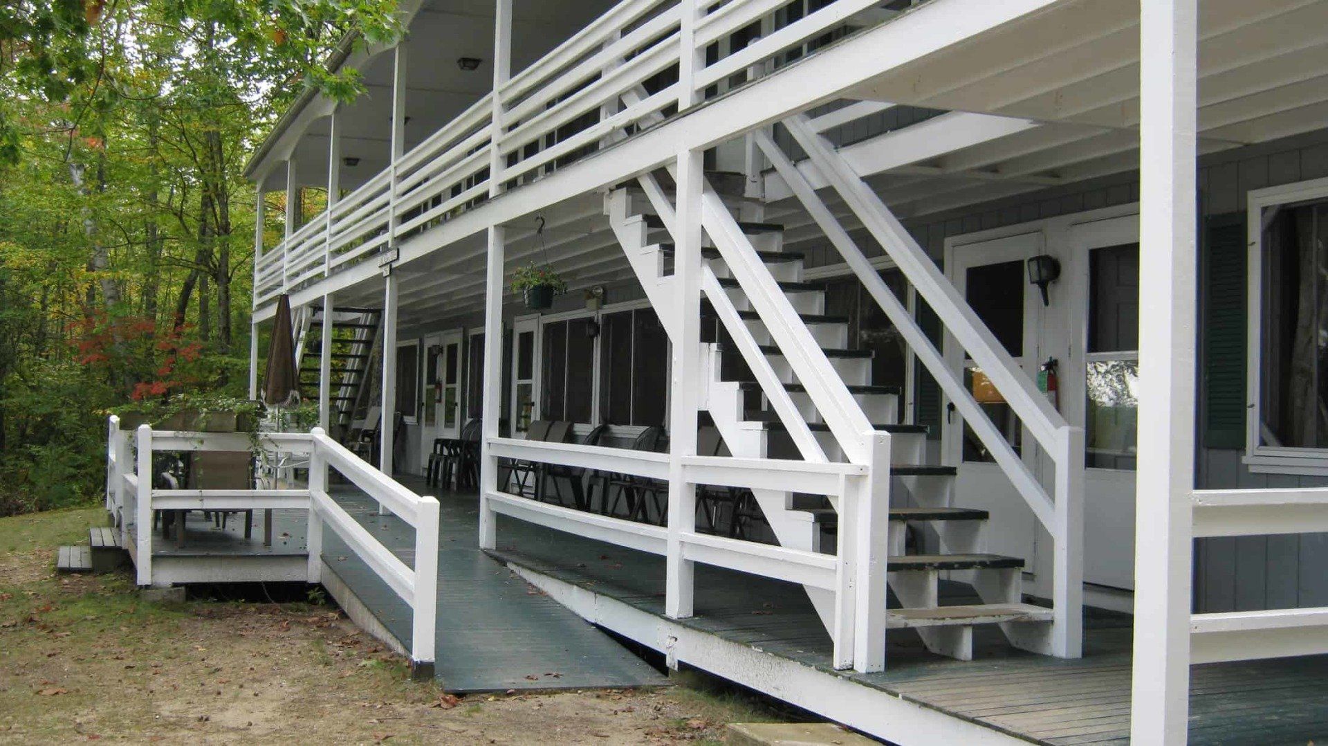 A white building with stairs and a ramp leading to it