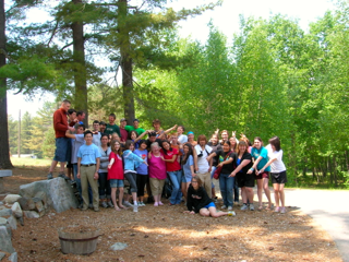 A group of people posing for a picture in a park