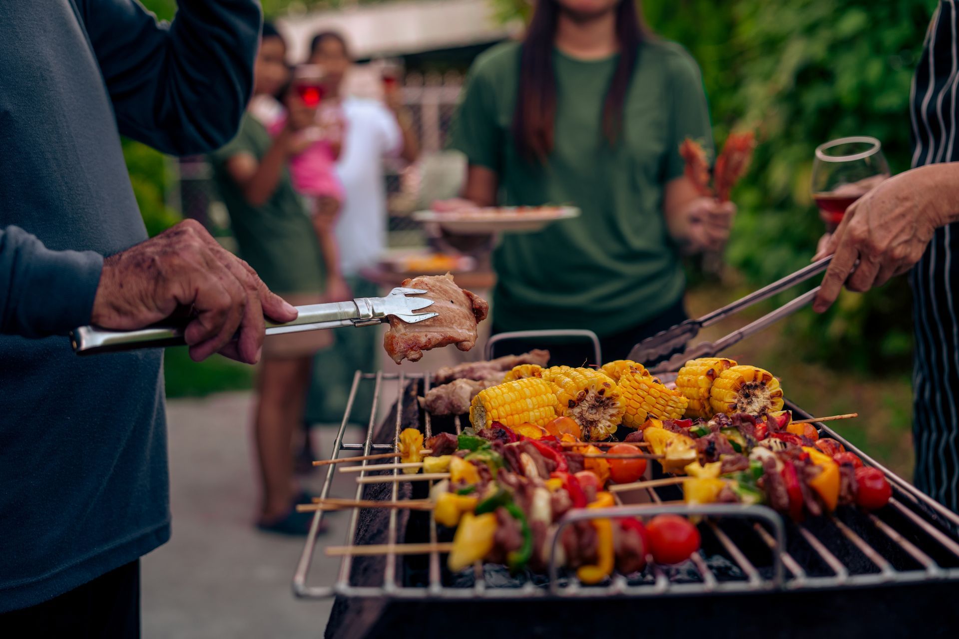 A group of people are cooking food on a grill.