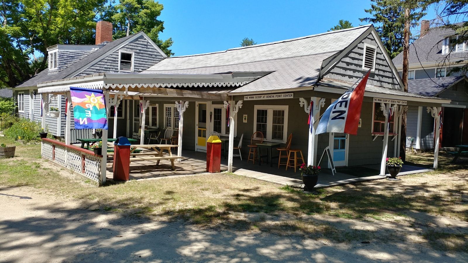 A large house with a rainbow flag on the front porch.