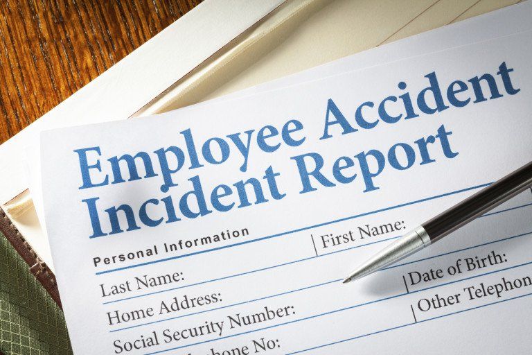 Pen on paper that says employee accident incident report