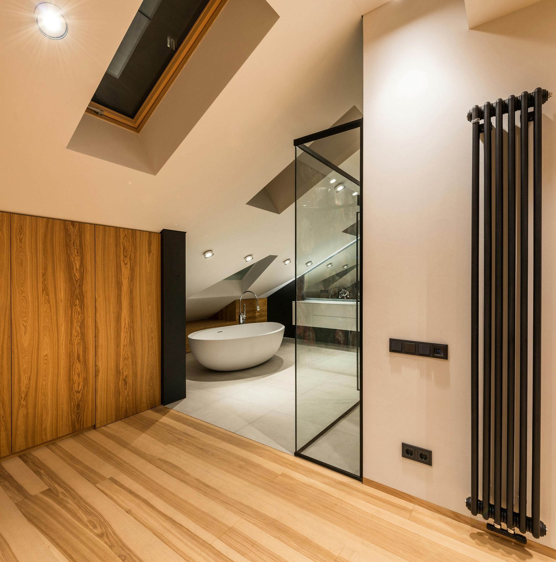 A bathroom with a tub and a skylight in the ceiling