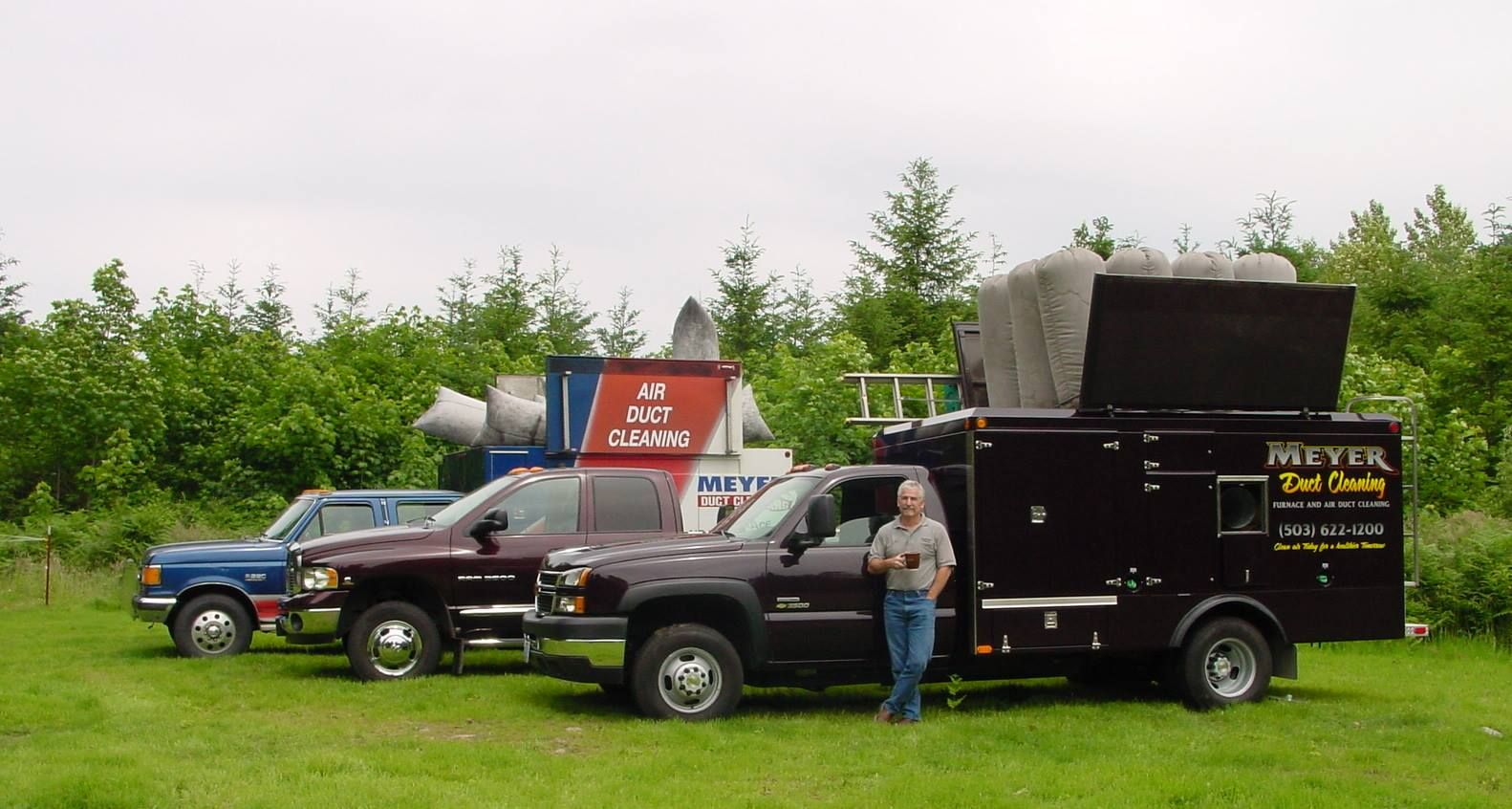 A man standing next to a truck that says meyer