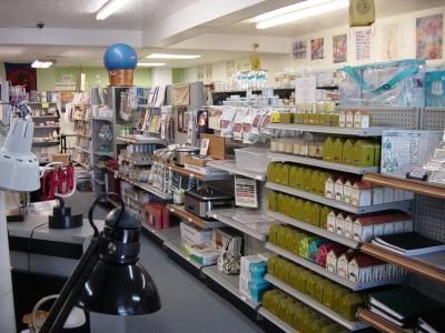 Interior of a retail store with shelves stocked with various products. Fluorescent lighting illuminates the space.