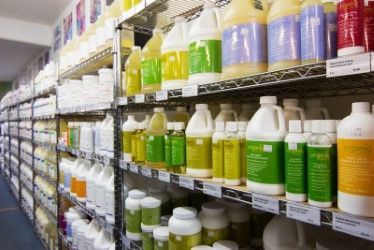 Shelves stocked with various cleaning product containers in a retail store.