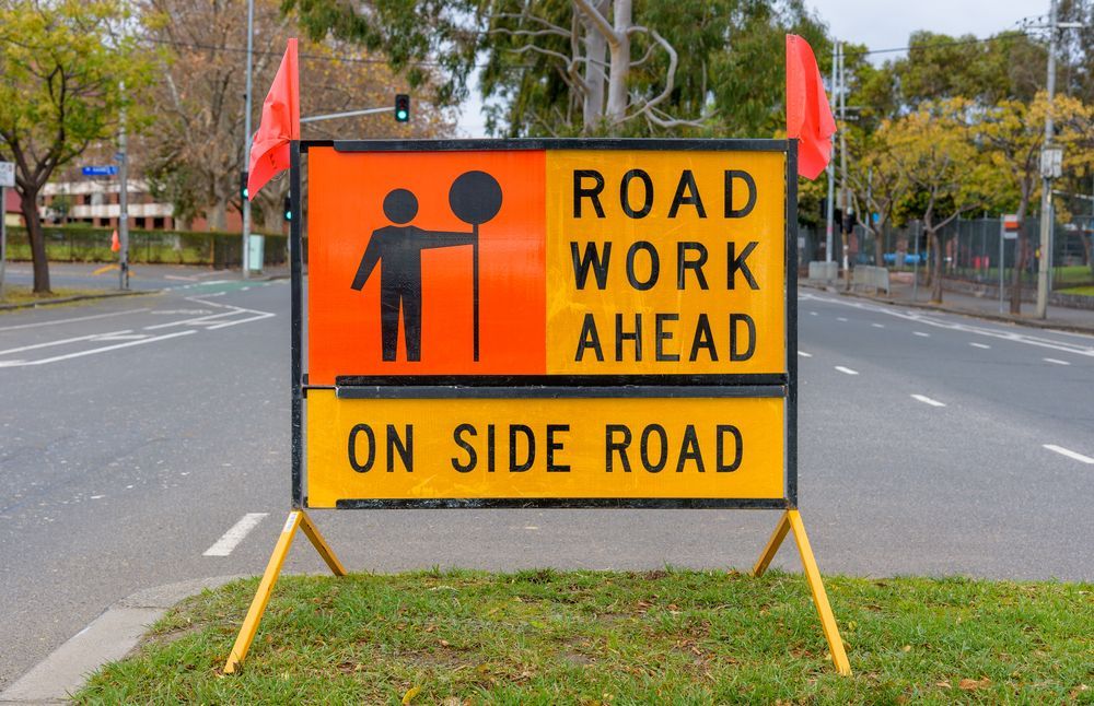 Road Work Sign on Side Road with Orange Flag, Warning of Road Work — Signvision In Dubbo, NSW