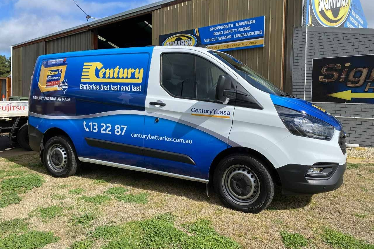 Blue and white Century van parked in front of a building with signage. The van has the business logo and phone number.