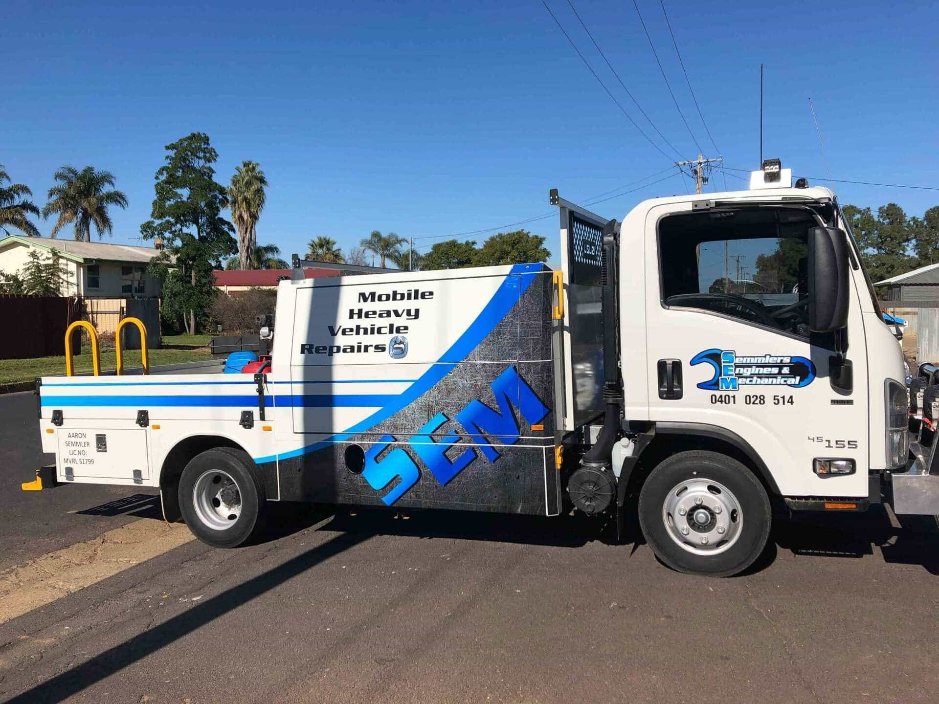 White Service Truck with Blue Graphics Parked on Street Under a Blue Sky — Signvision In Dubbo, NSW