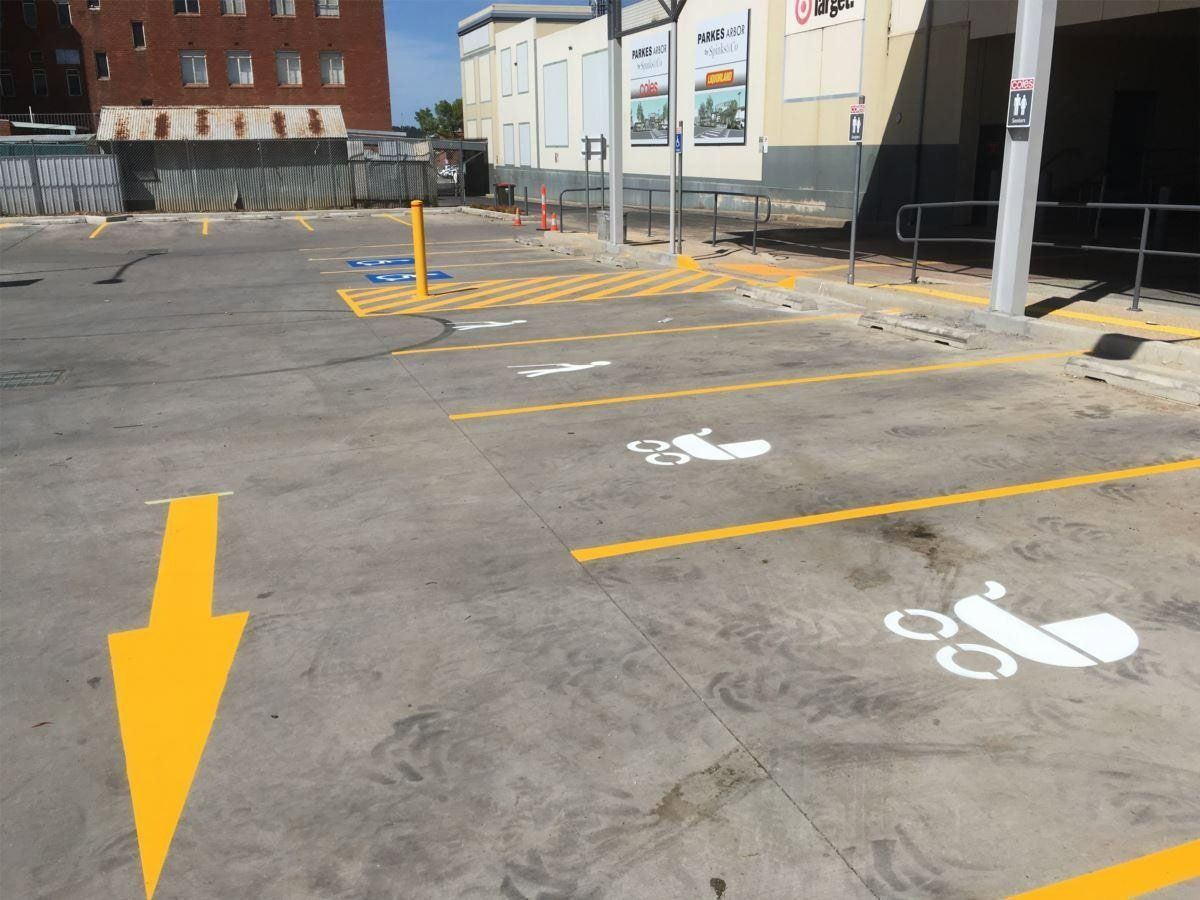 Parking Lot with Yellow Arrows, and Spaces Marked for Strollers — Signvision In Dubbo, NSW