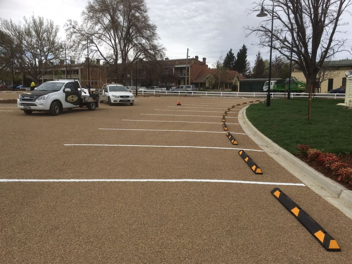 A Parking Lot with White-Lined Spaces, Two Parked Cars — Signvision In Dubbo, NSW