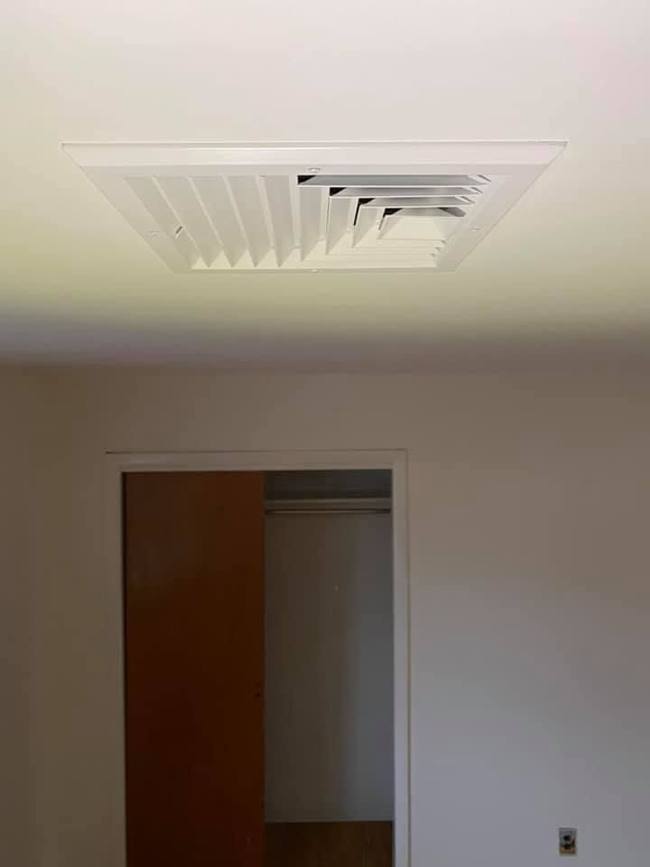 Ceiling vent above an open closet doorway in a plain room Ceiling vent above an open closet doorway in a plain room