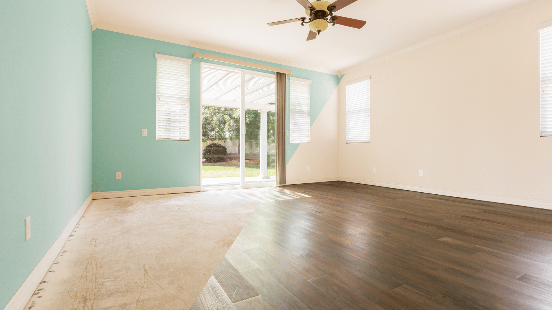 An empty living room with hardwood floors and a ceiling fan.