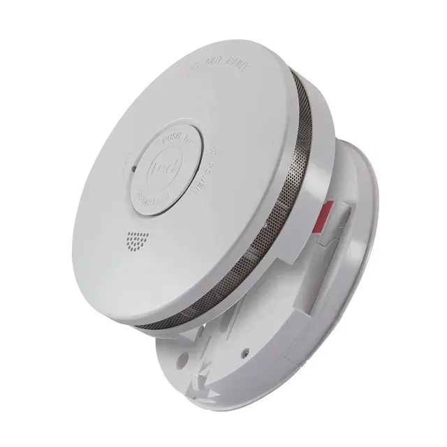 White Smoke Detector Mounted on a Gray Wall — FNQ Smoke Alarms & Maintenance in Herberton, QLD