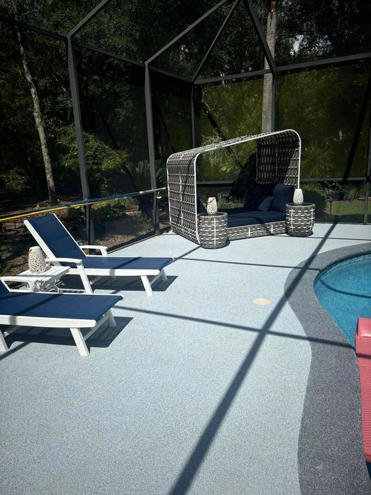 A patio with chairs and a swing next to a pool.