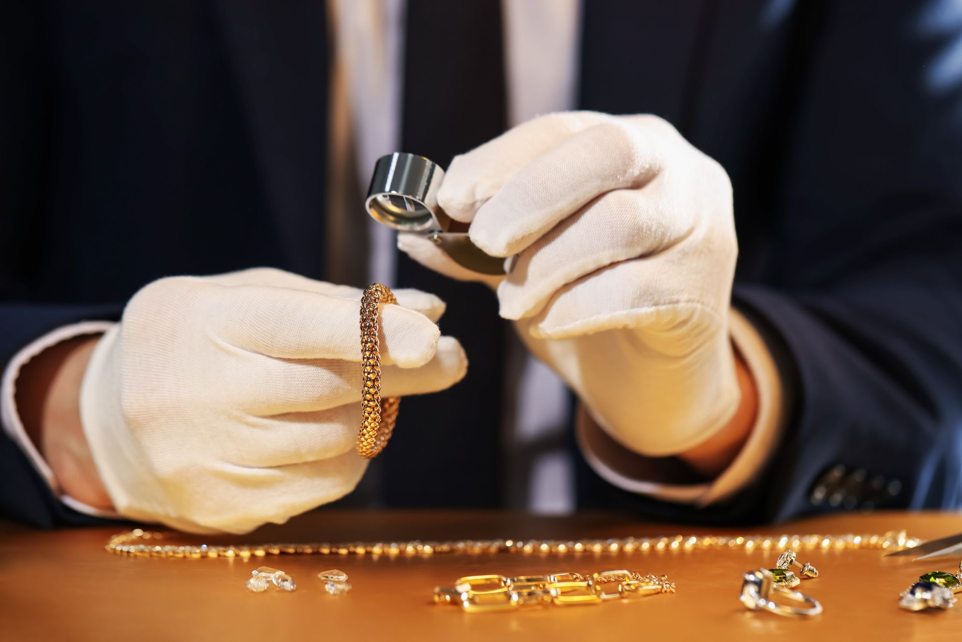 Close-up of a valuer with a loupe performing a jewellery valuation service.
