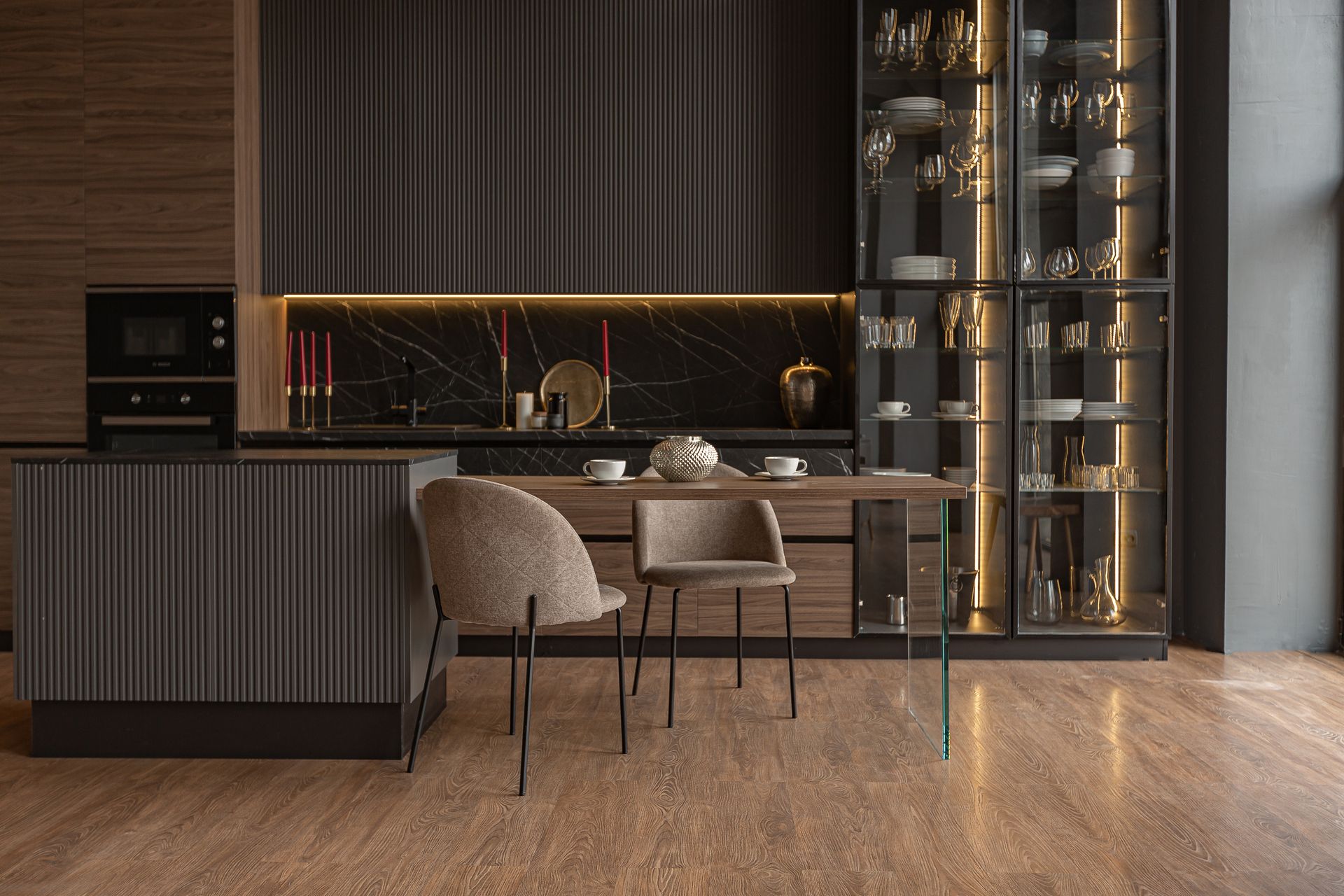 A kitchen with a dining table and chairs in it.