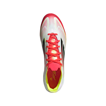 The bottom of a pair of white and red adidas soccer cleats.
