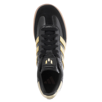 The bottom of a pair of black and gold adidas shoes