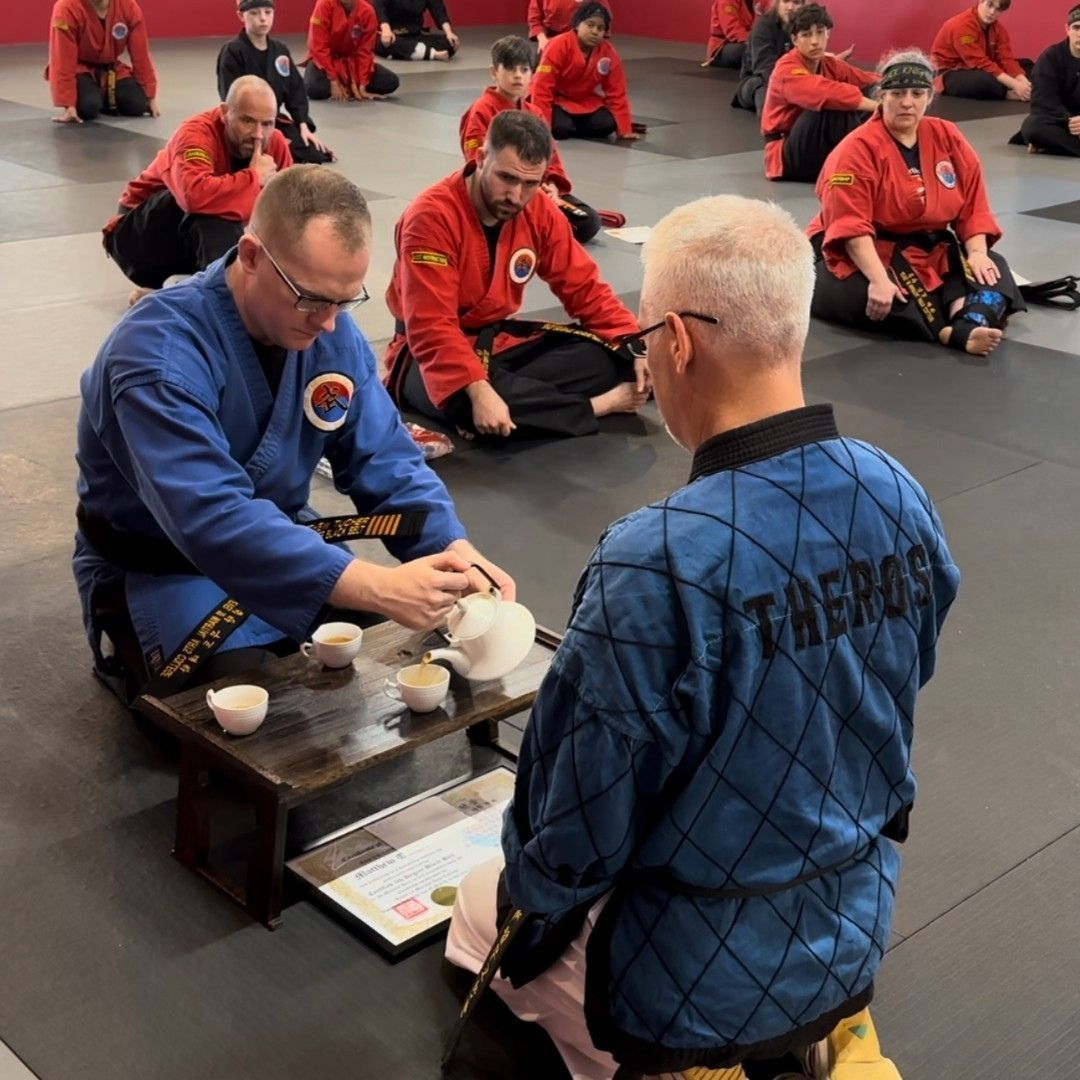 A group of men are practicing karate in a gym.