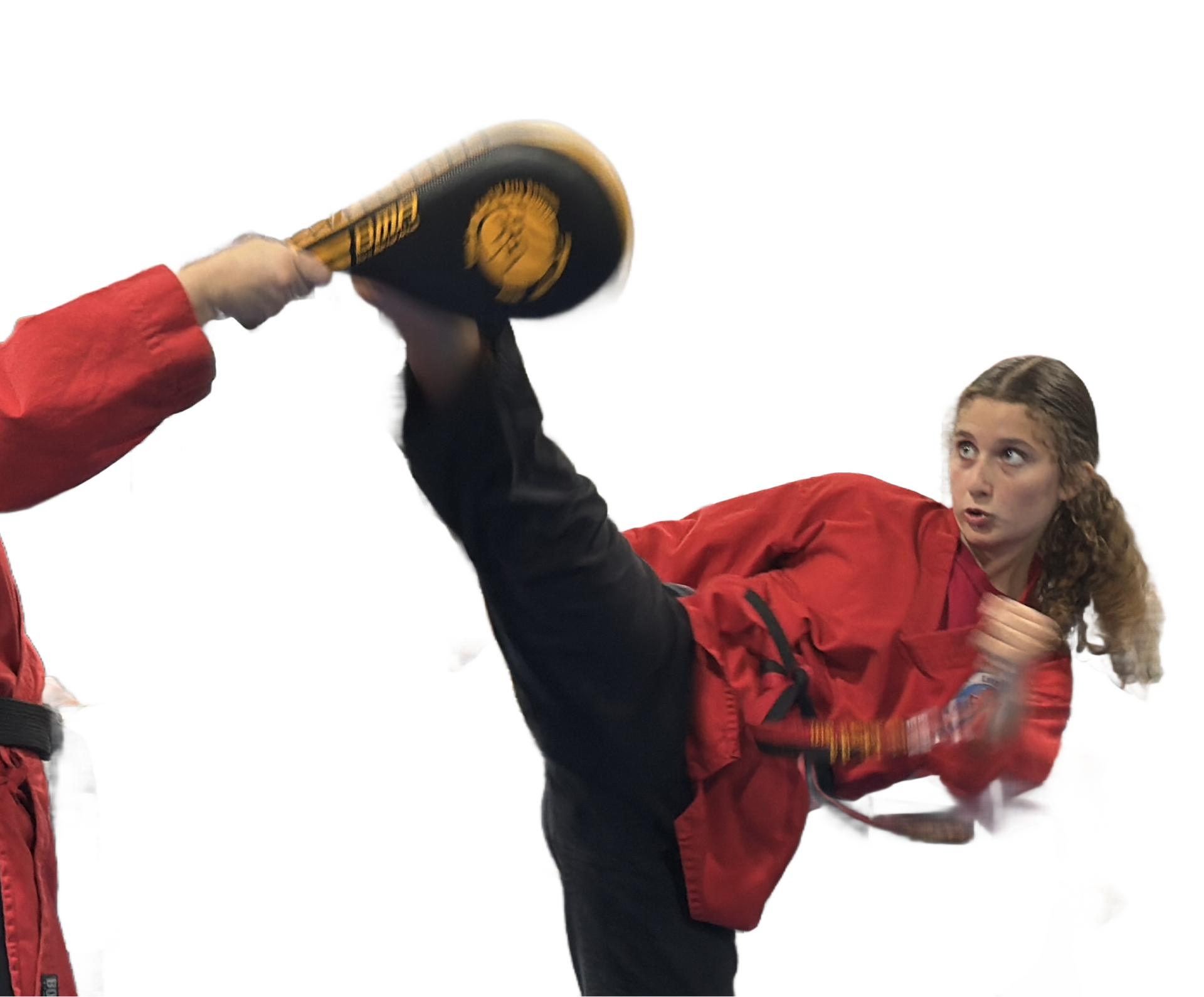 Martial artist in red shirt delivers a high kick toward a training pad on a white background