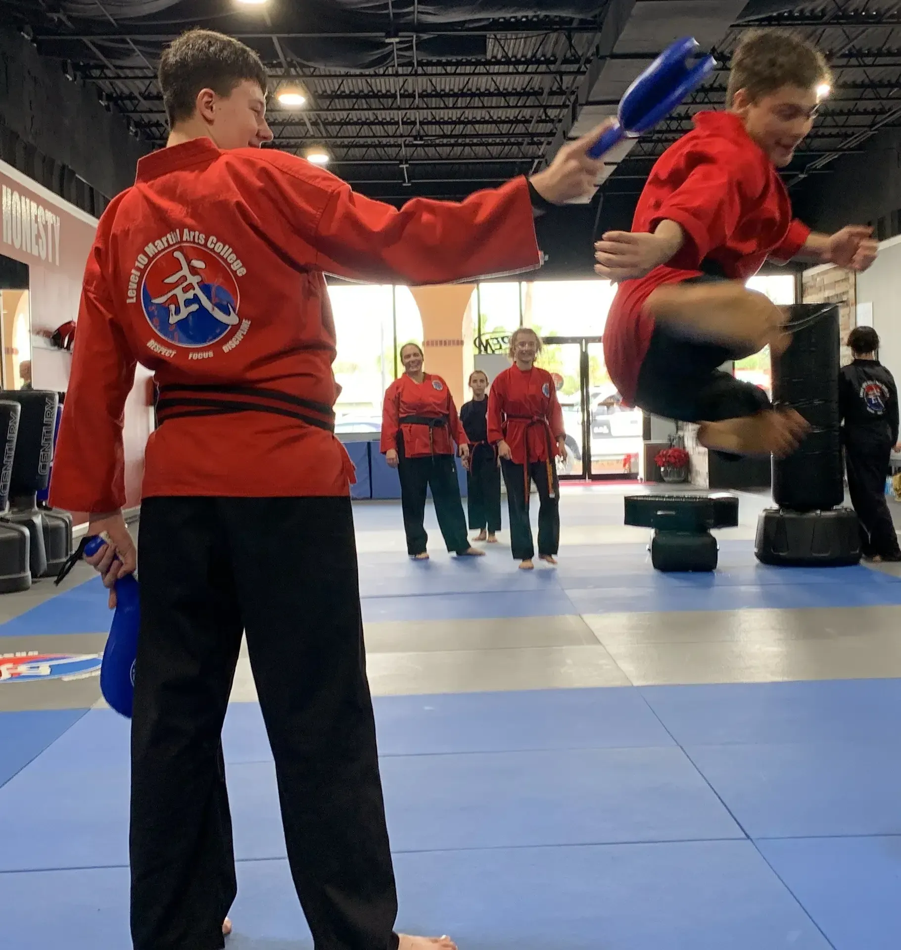 Teenage boy performs Karate kick at Level 10 Martial Arts College in Palm Harbor