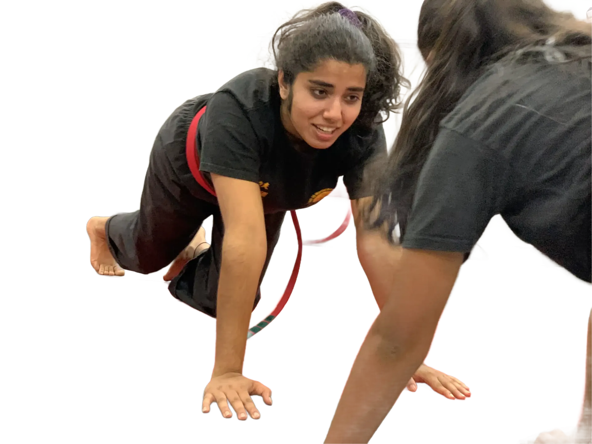Two people in athletic wear crawl on hands and knees in a training exercise.
