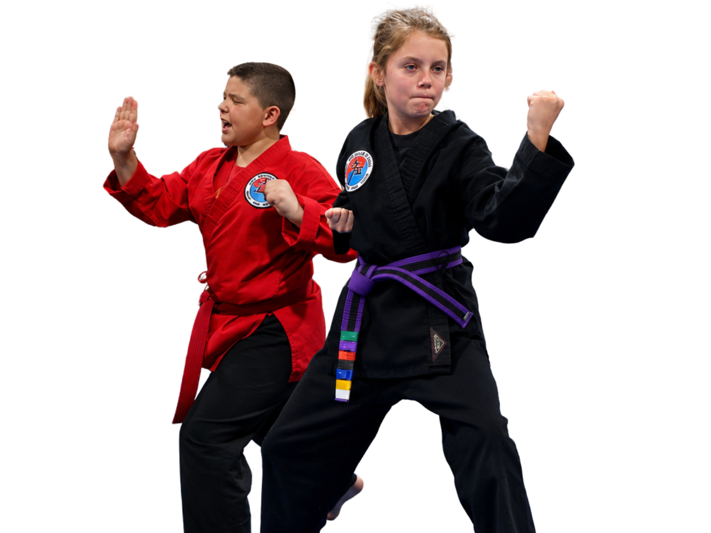 A boy and two girls are wearing karate uniforms and pointing at the camera