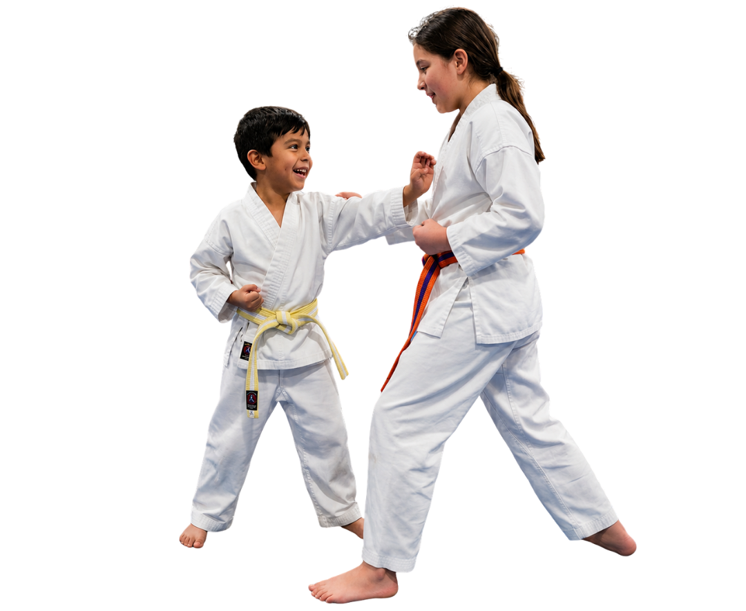 A group of kids in karate uniforms are sitting on the floor drinking water