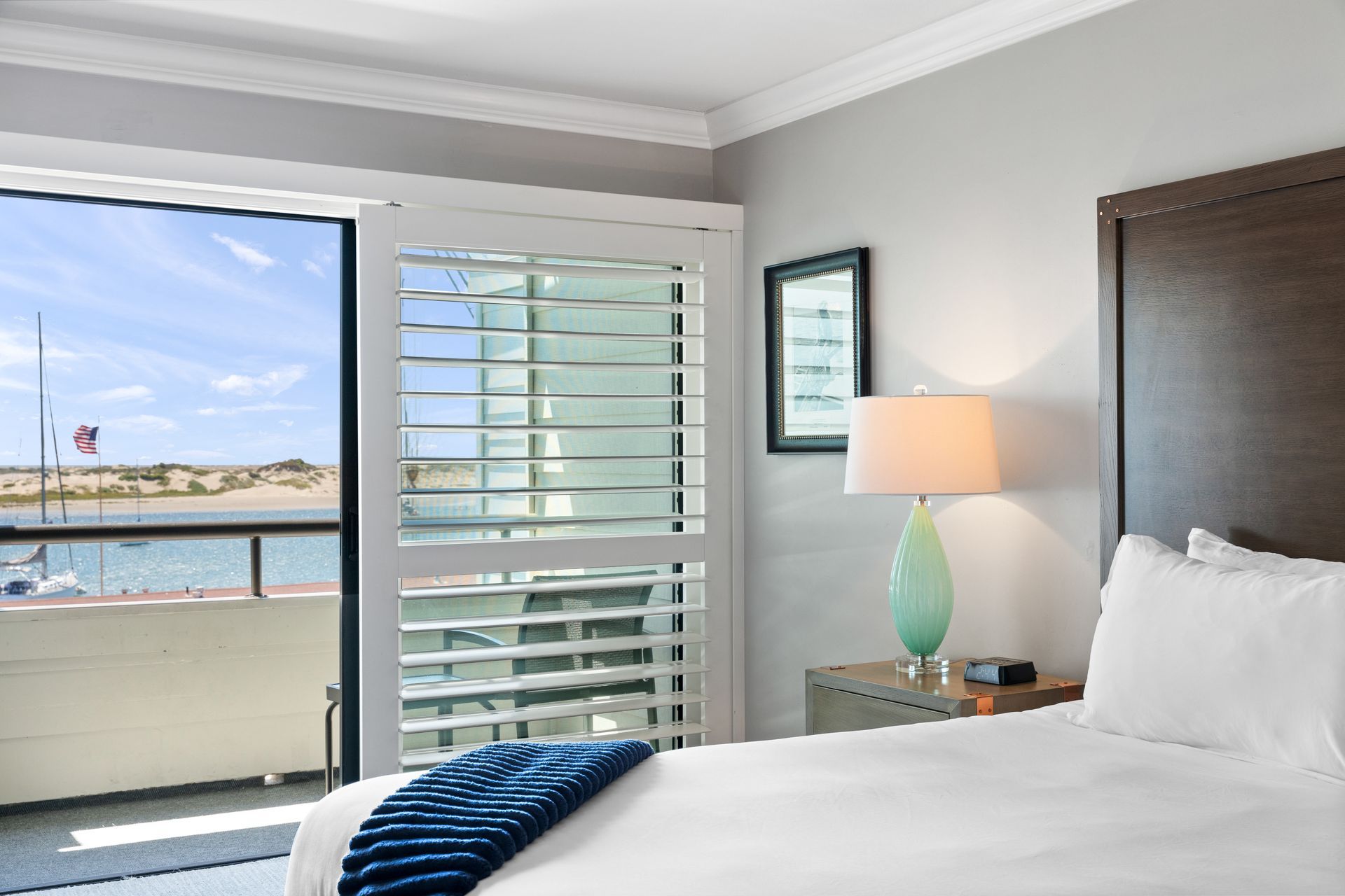 A hotel room with a king size bed and a view of the ocean