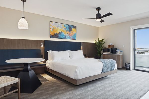 A hotel room with a king size bed and a fireplace