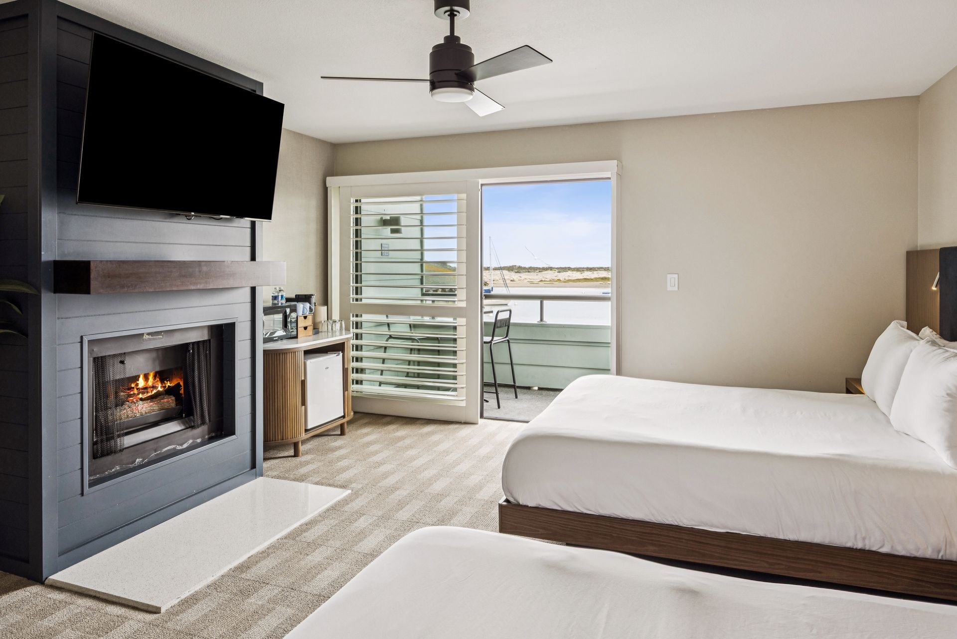 A hotel room with two beds and a ceiling fan