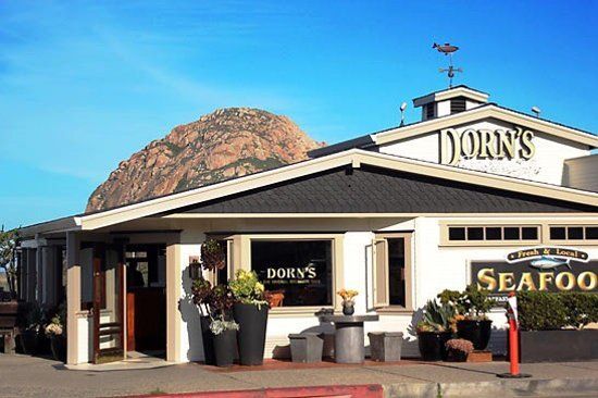 A restaurant called dory 's seafood with a mountain in the background