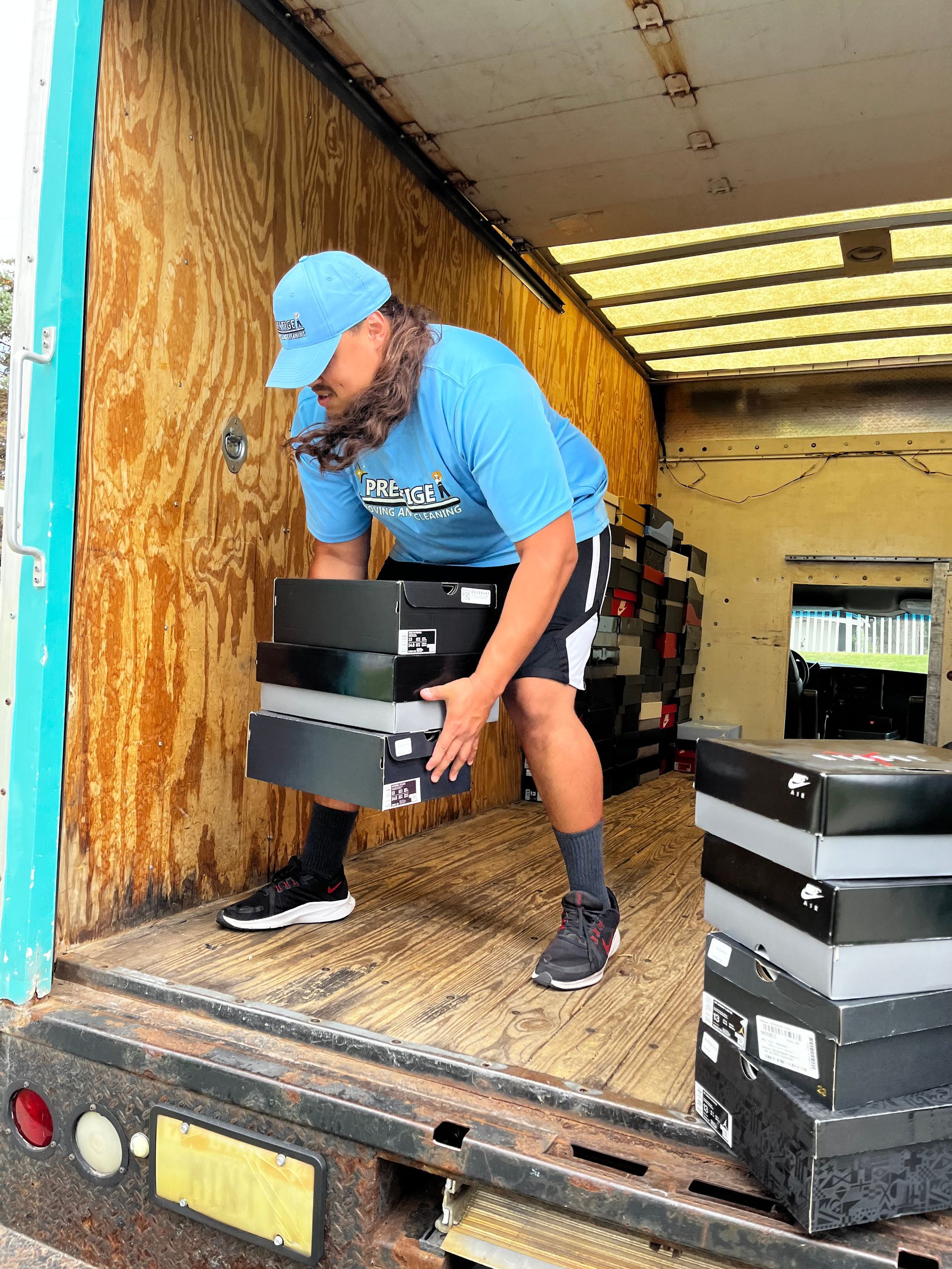 A man is loading boxes into a truck.